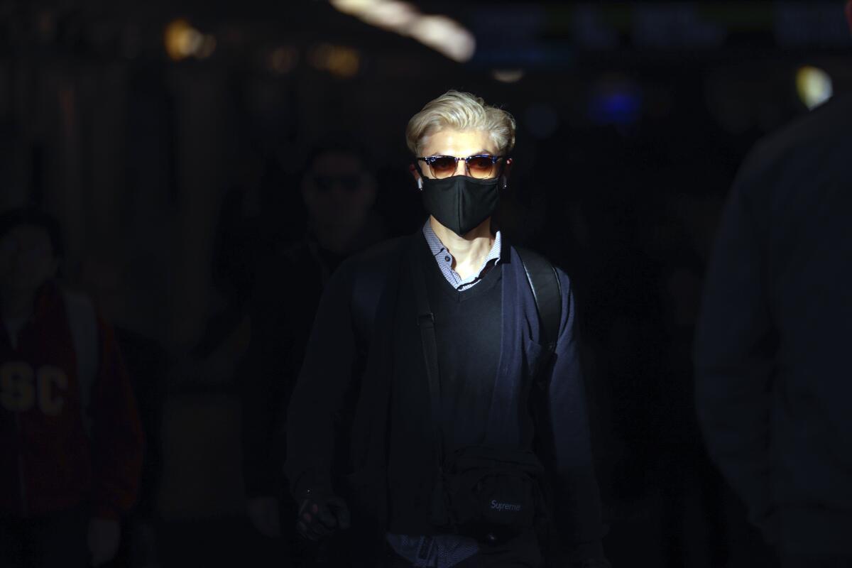 Some commuters at Union Station adorn breathing masks.