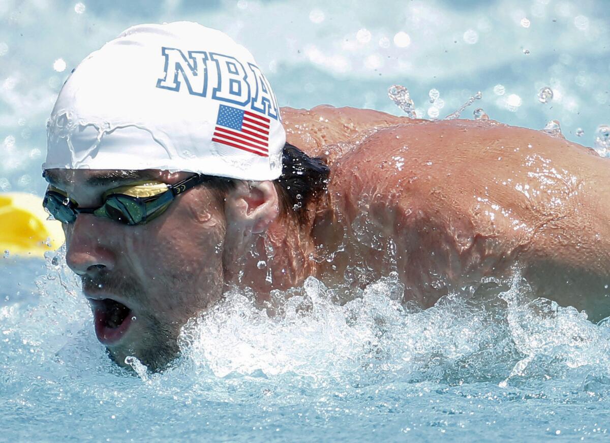 Michael Phelps competes in the 100-meter butterfly during the Arena Grand Prix swim meet Thursday in Mesa, Ariz.