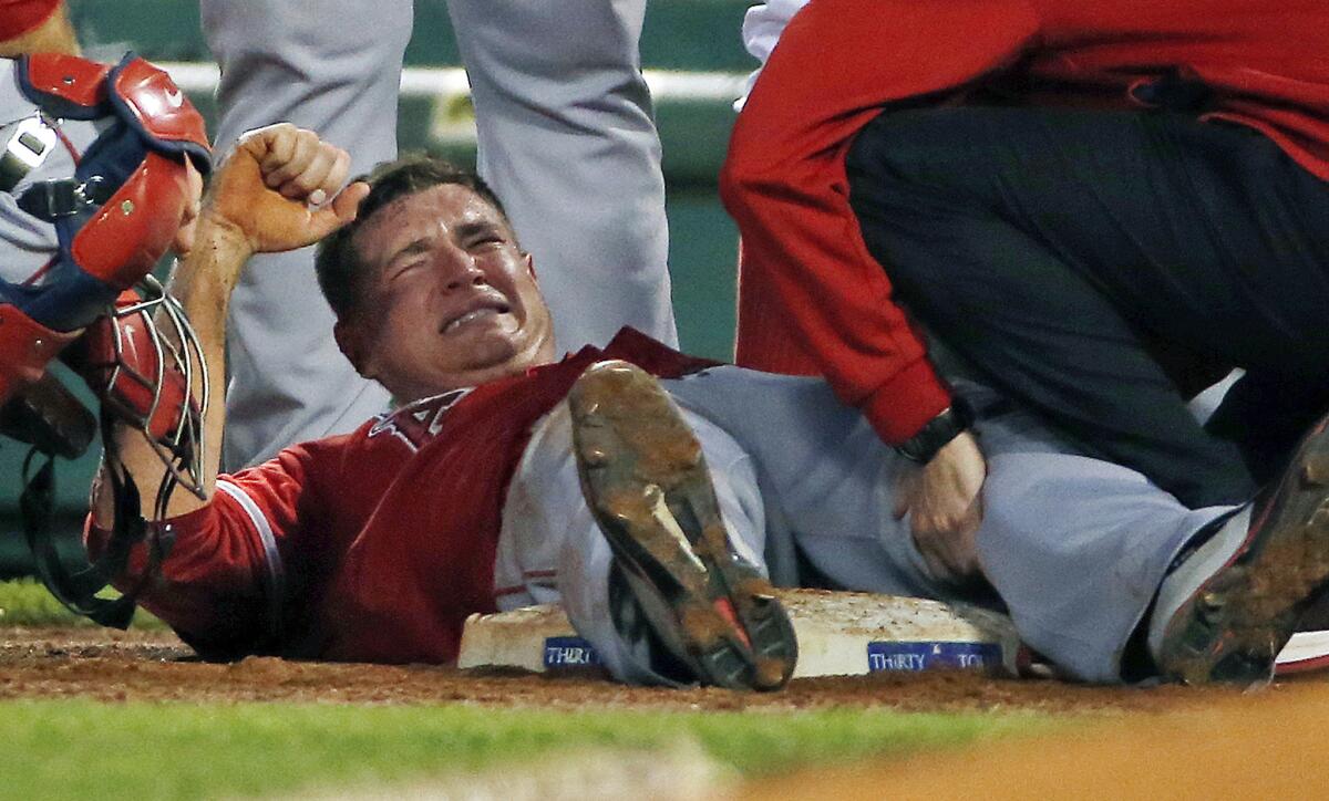 Angels starting pitcher Garrett Richards is examined by a team trainer after suffering a knee injury during the second inning of Wednesday's game against the Boston Red Sox at Fenway Park.