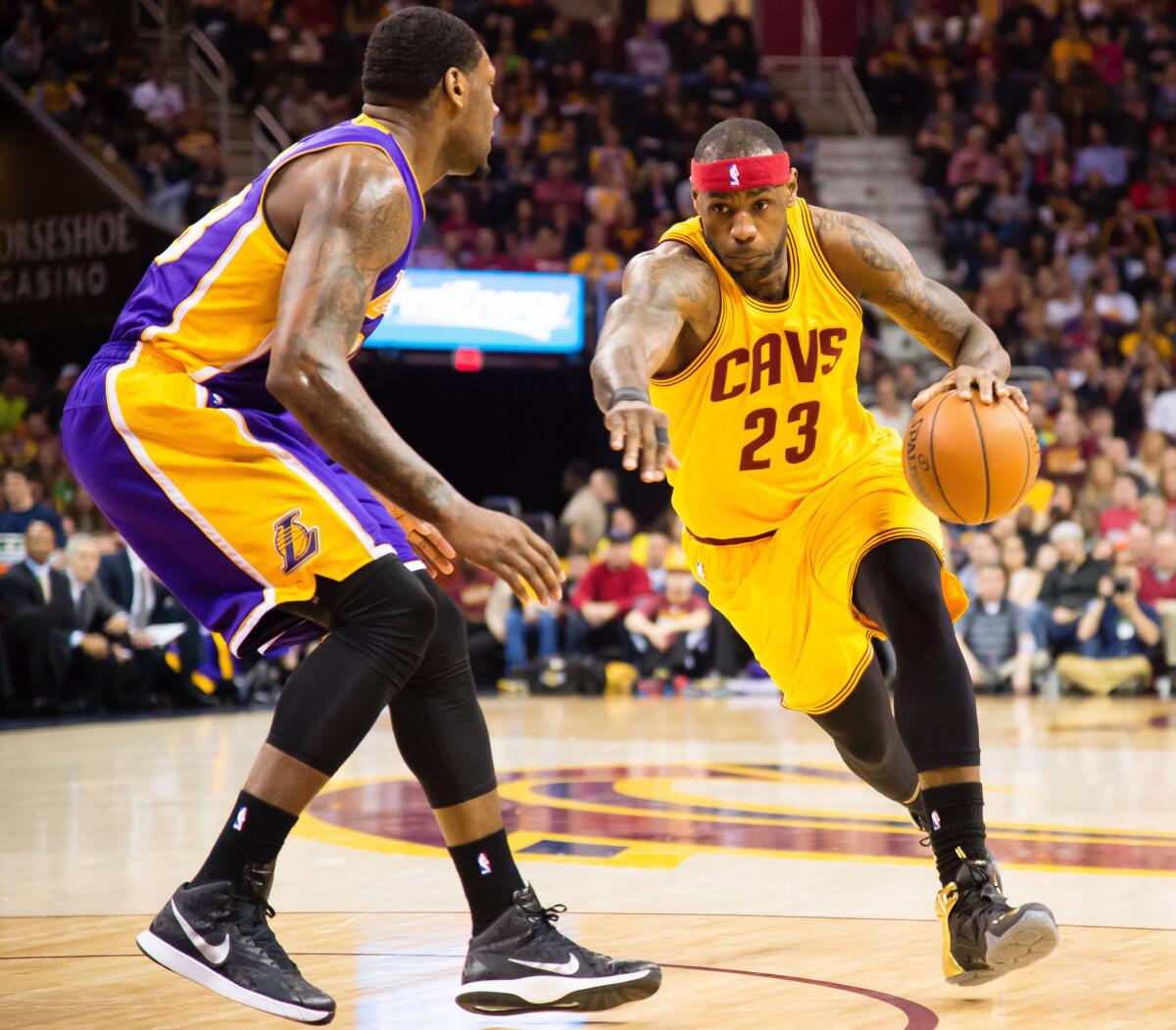 Cavaliers forward LeBron James (23) looks to drive against Lakers center Tarik Black in the first half.