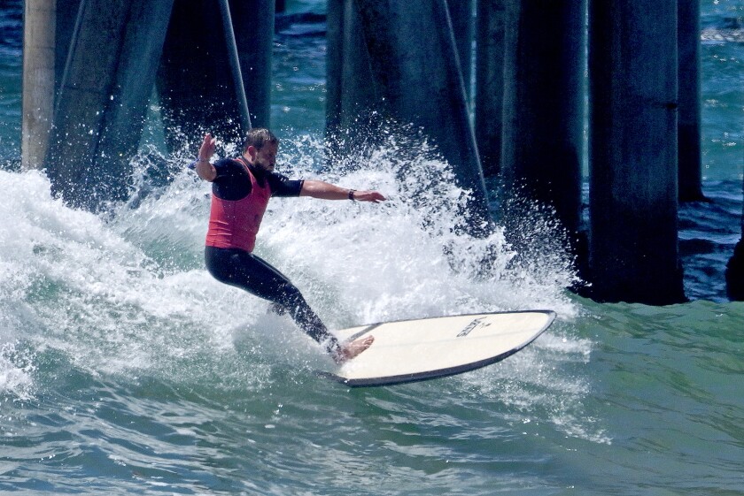Justin Quintal of the United States rides the longboard during the U.S. Open of Surfing in Huntington Beach on Friday.