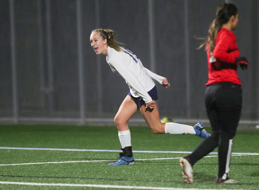 Newport Harbor's Sam Wallis (19) scores in the Battle of the Bay girls' soccer match on Thursday.