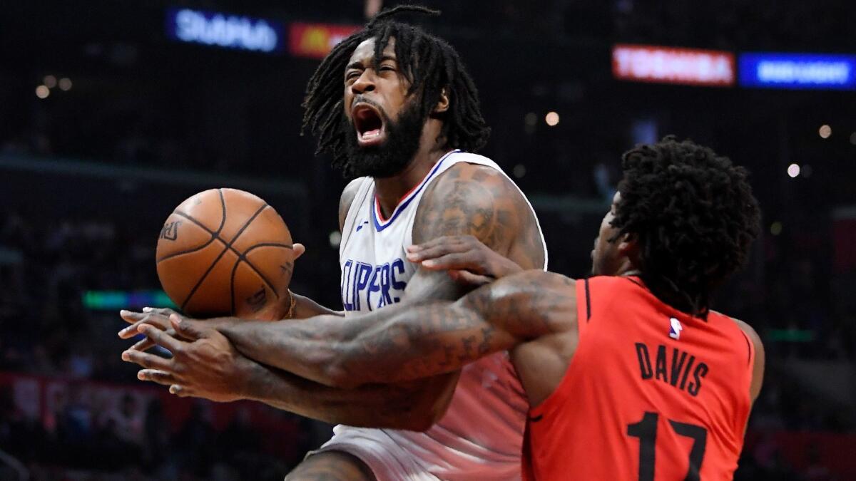Portland Trail Blazers forward Ed Davis, right, reaches in on Clippers center DeAndre Jordan during the first half on Tuesday.
