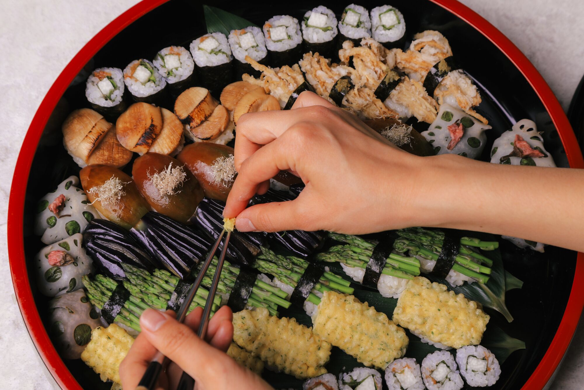 Yoko Hasebe puts the finishing touches on a platter of vegan sushi.