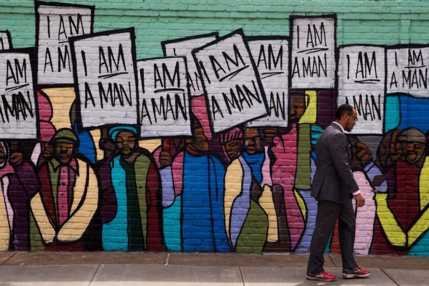 Mandatory Credit: Photo by RICK MUSACCHIO/EPA-EFE/REX/Shutterstock (9490376s) People pass a painted wall near the Lorraine Motel and National Civil Rights Museum which is the site of the observance of the 50th anniversary of the assassination of Dr. Martin Luther King Jr. in Memphis, Tennessee, USA, 03 April 2018. King was shot and killed as he stood on the balcony of the Loraine Motel in front of room 306 where he was staying on 04 April 1968. He was in Memphis to support striking sanitation workers. I am a Man was the slogan of the striking workers. 50th anniversary of the assassination of Martin Luther King Jr., Memphis, USA - 29 Mar 2018 ** Usable by LA, CT and MoD ONLY **