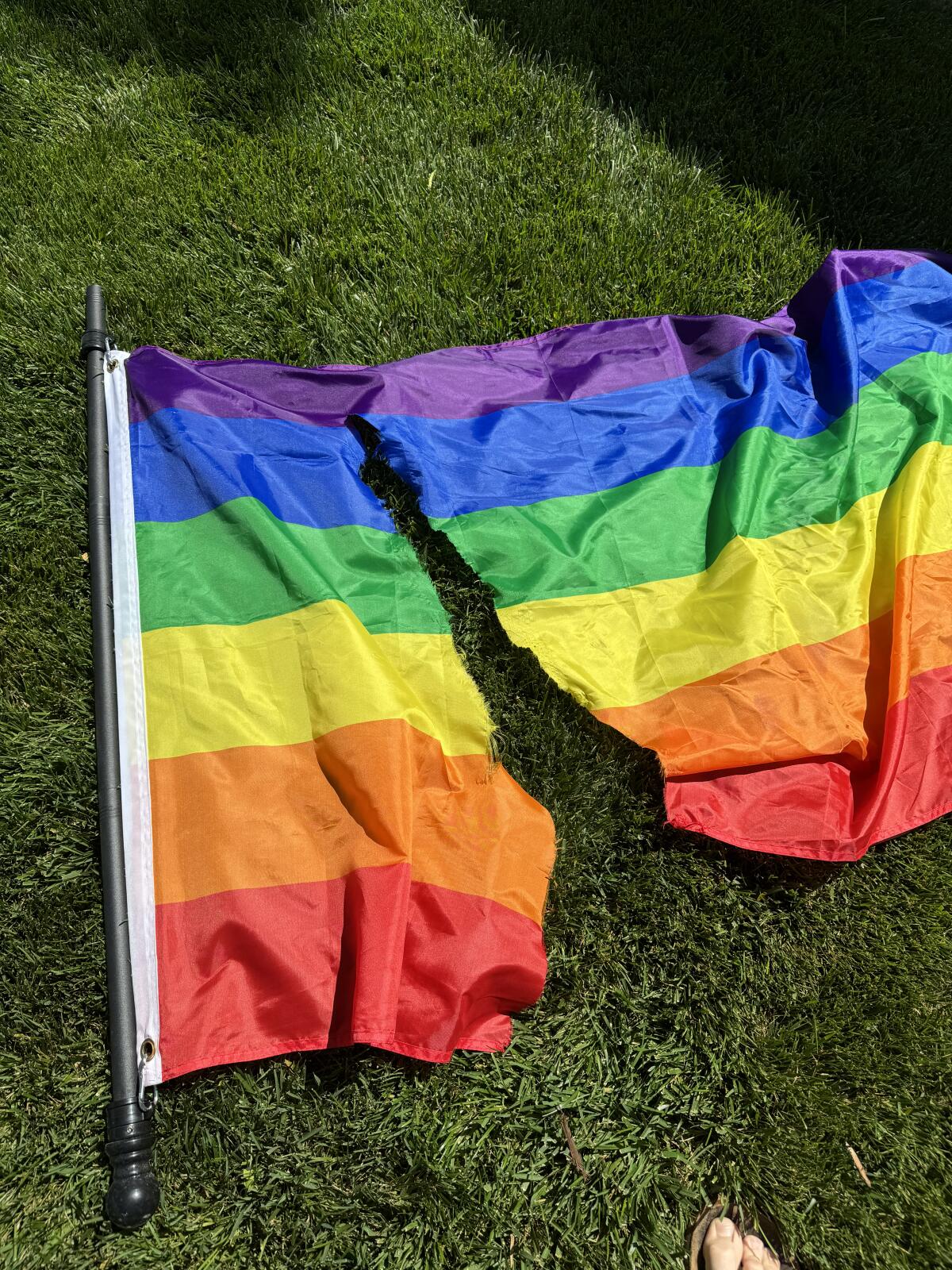 A rainbow Pride flag that was hung outside Jake Nolan's house in Anaheim was cut with a knife and ripped down.