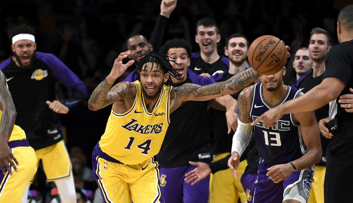 Lakers forward Brandon Ingram steals an inbound ball from Kings guard Cameron Reynolds (13) late in the fourth quarter Thursday night.