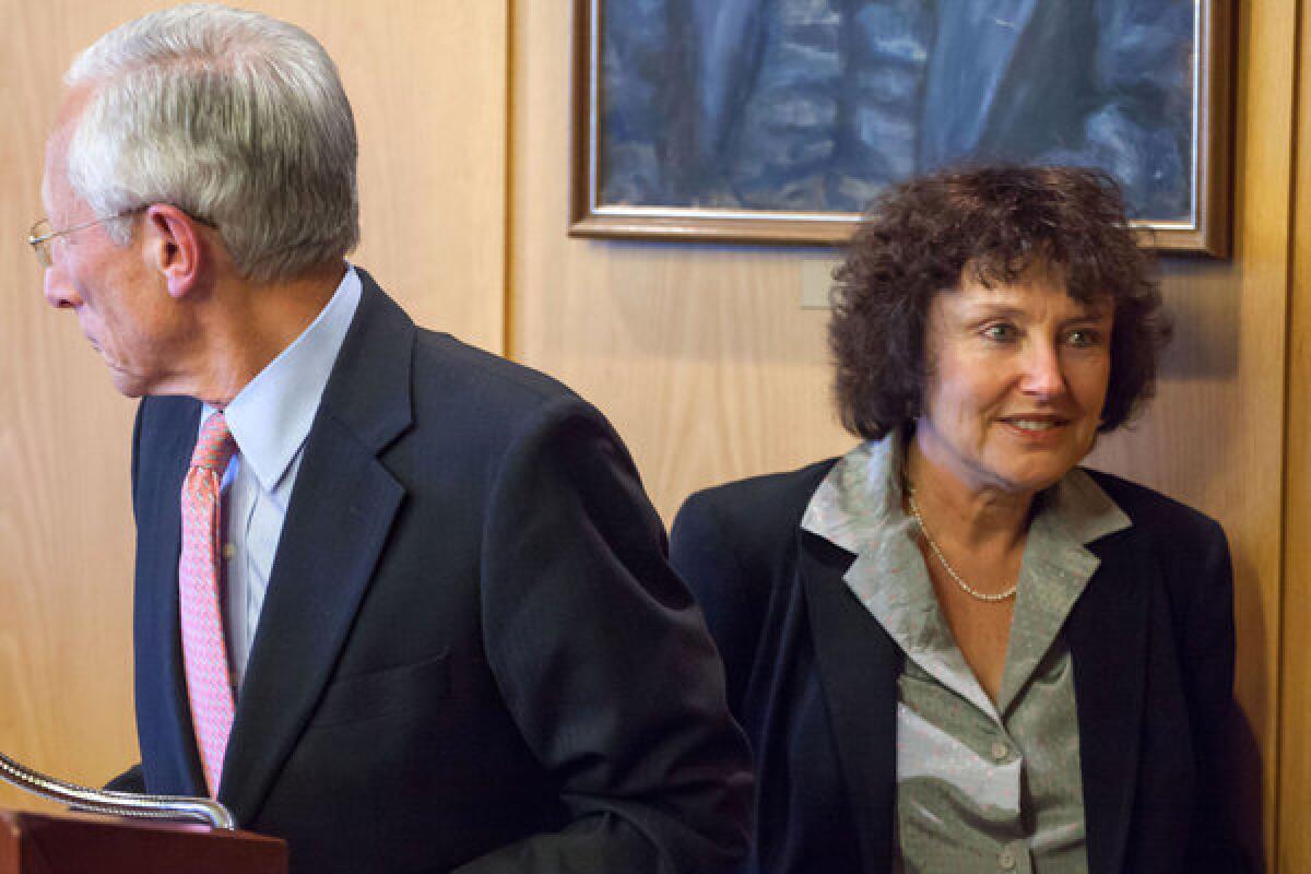 In a file photo taken Jan. 1, 2013, Karnit Flug, right, walks past the Bank of Israel's governor at the time, Stanley Fischer, during a news conference in Jerusalem. Flug was appointed to the governor's post Sunday.