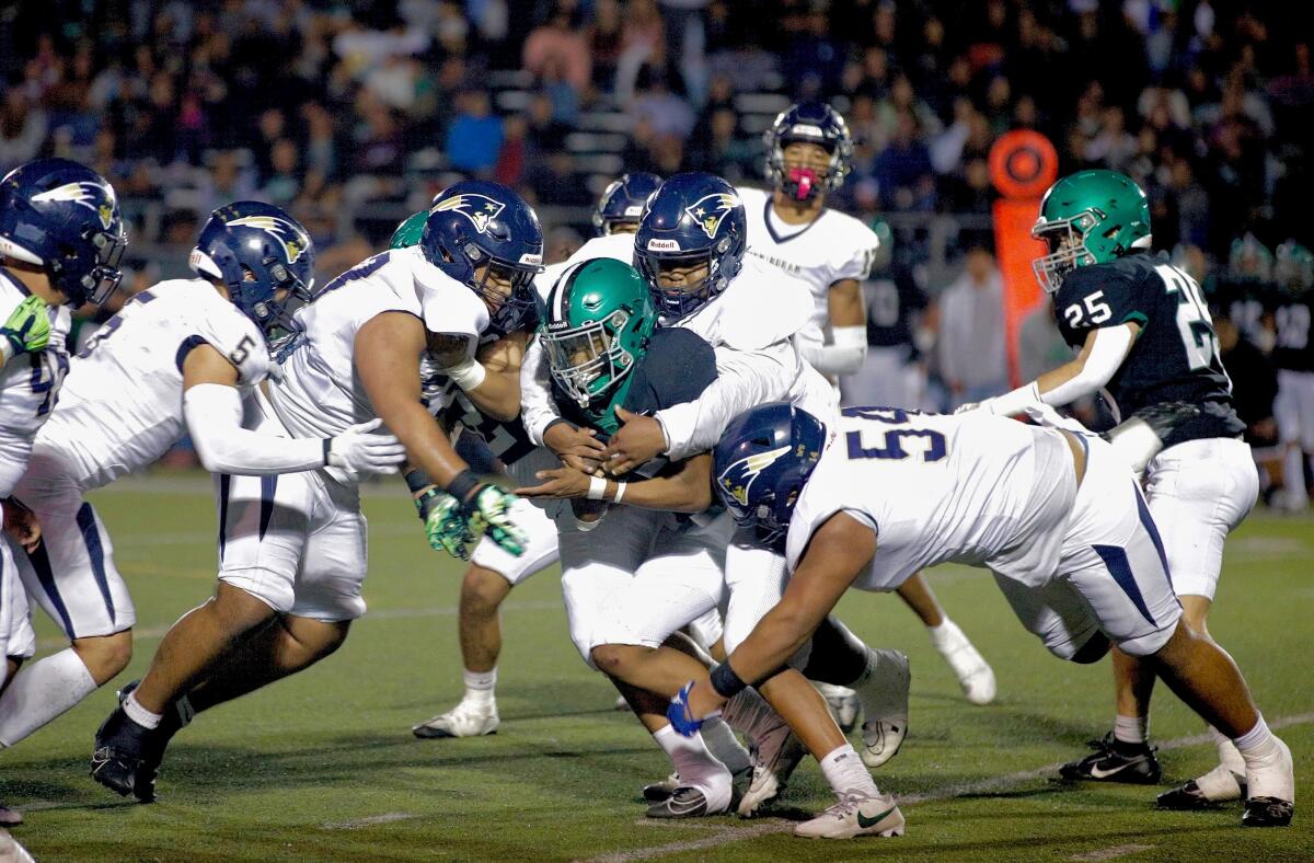 Granada Hills running back Darrell Stanley is tackled in the backfield by a swarm of Birmingham defenders on Friday night.
