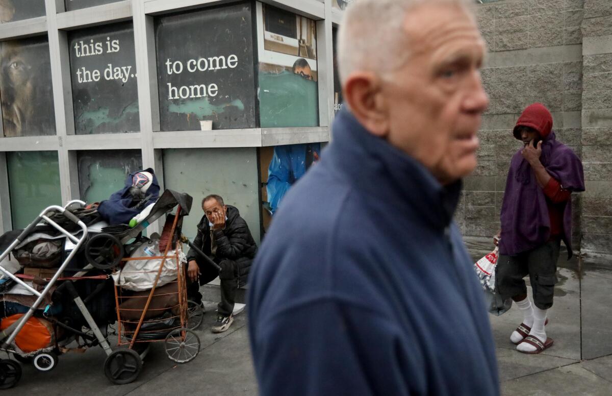 LOS ANGELES, CA - SEPTEMBER 29, 2023 - U.S. District Judge David O. Carter, 79, pauses in front of the Midnight Mission while leading a tour of Skid Row in downtown Los Angeles on September 29, 2023. After appointing retired judge Jay C. Gandhi to monitor of L.A. County's settlement of the L.A. Alliance case, Judge Carter challenged Gandhi to prove his passion for the job by meeting him on Skid Row. Judge Gandhi showed up at 6;30 a.m. for the tour. (Genaro Molina / Los Angeles Times)