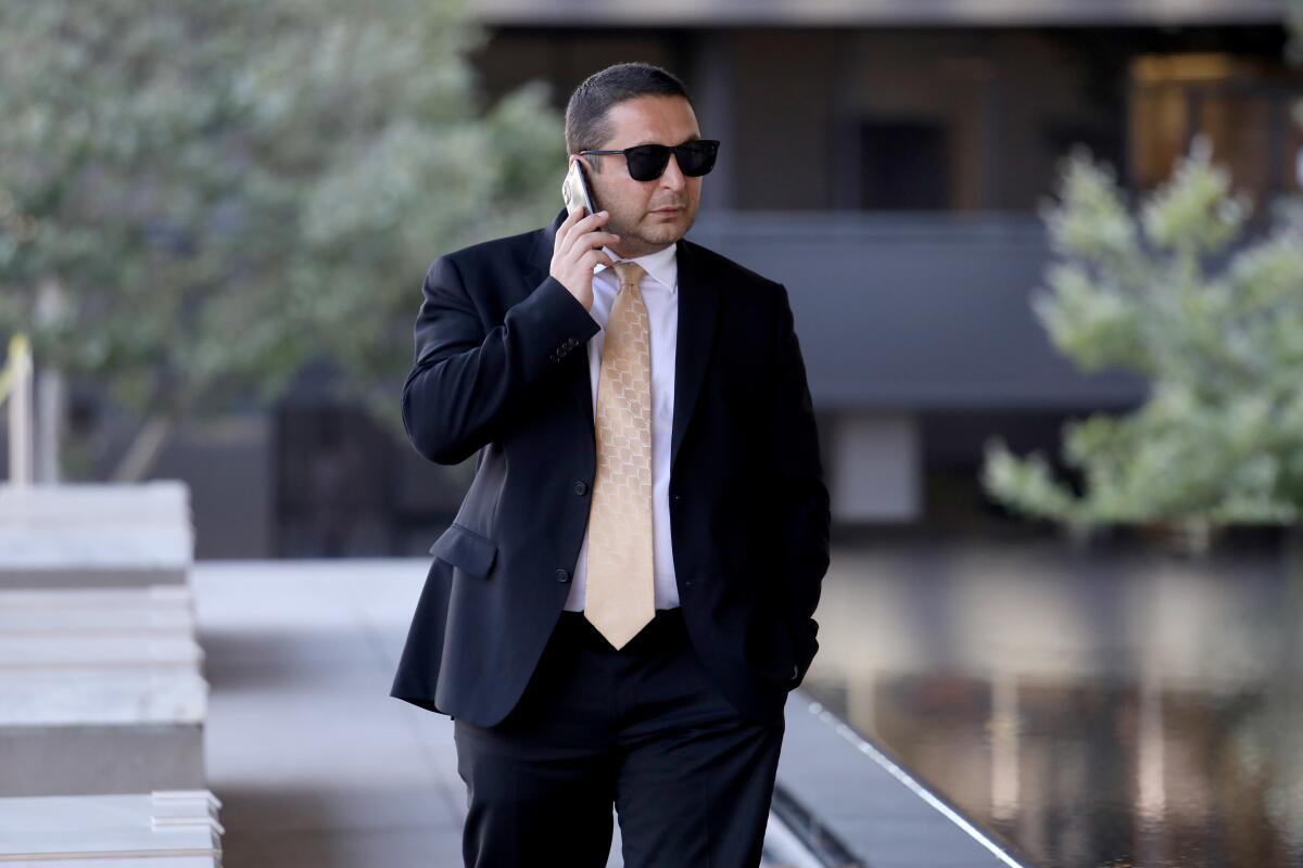 Artur Ayvazyan speaks on a cellphone outside a federal courthouse in downtown Los Angeles.