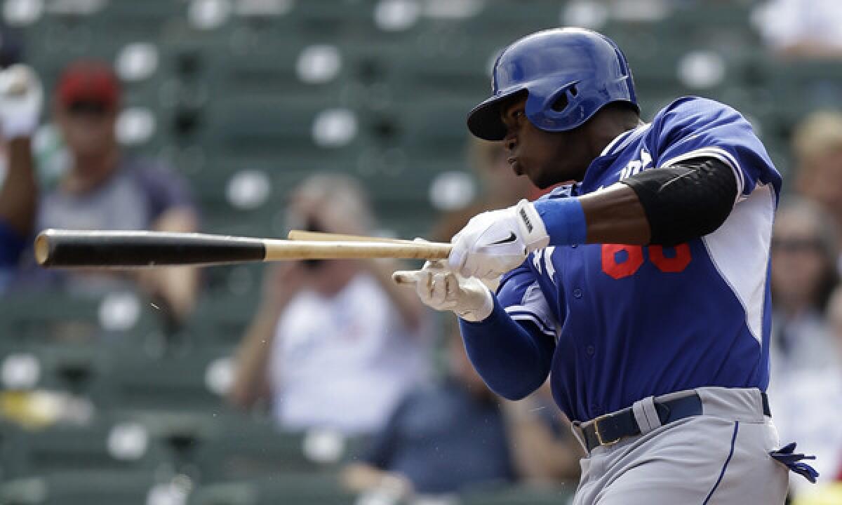 Dodgers right fielder Yasiel Puig hits a broken-bat single against the Arizona Diamondbacks in Cactus League play Wednesday. Puig batted in the leadoff spot against the San Diego Padres on Sunday.