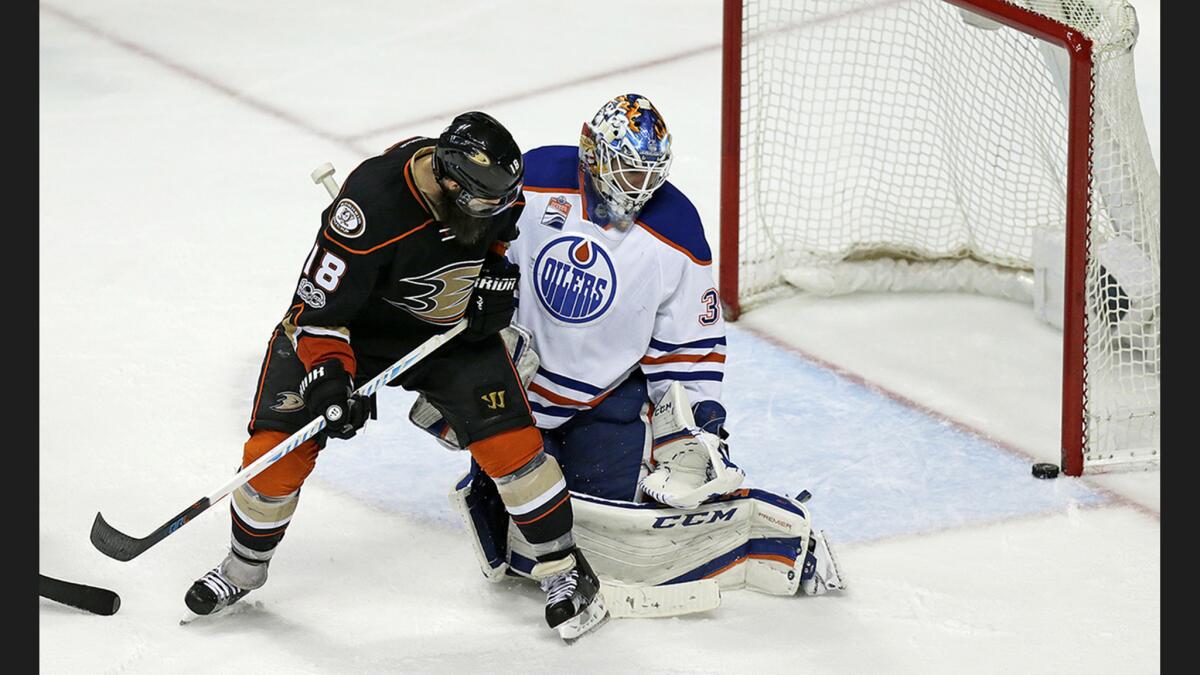 Ducks right wing Patrick Eaves (18) watches as a shot on goal hits the post behind Oilers goaltender Cam Talbot during Game 2 at Honda Center on Friday.