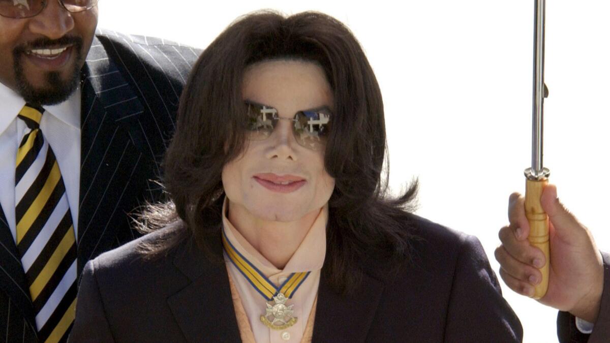 Michael Jackson enters court in Santa Barbara County with a bodyguard in Santa Maria, Calif., on March 30, 2005.