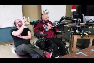 Man operates robotic arm with his brain