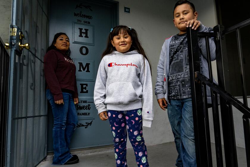 EL CAJON, CA -APRIL 13, 2023: Iraides Gonzalez with two of her three children, Brianna, 7, and Brandon, 9, has had to bring other tenants into her apartment to afford the rent increases since Blackstone bought her apartment building on April 13, 2023 in El Cajon, California. Six people live in her 3 bedroom apartment, including herself and her three children. She makes $15/hour as a cashier. "Am I able to get enough money together for this month's rent," she worries. If her rent is three days late she is slapped with a $75 late fee. Blackstone used pension fund investments to purchase her building along with many others in California.(Gina Ferazzi / Los Angeles Times)