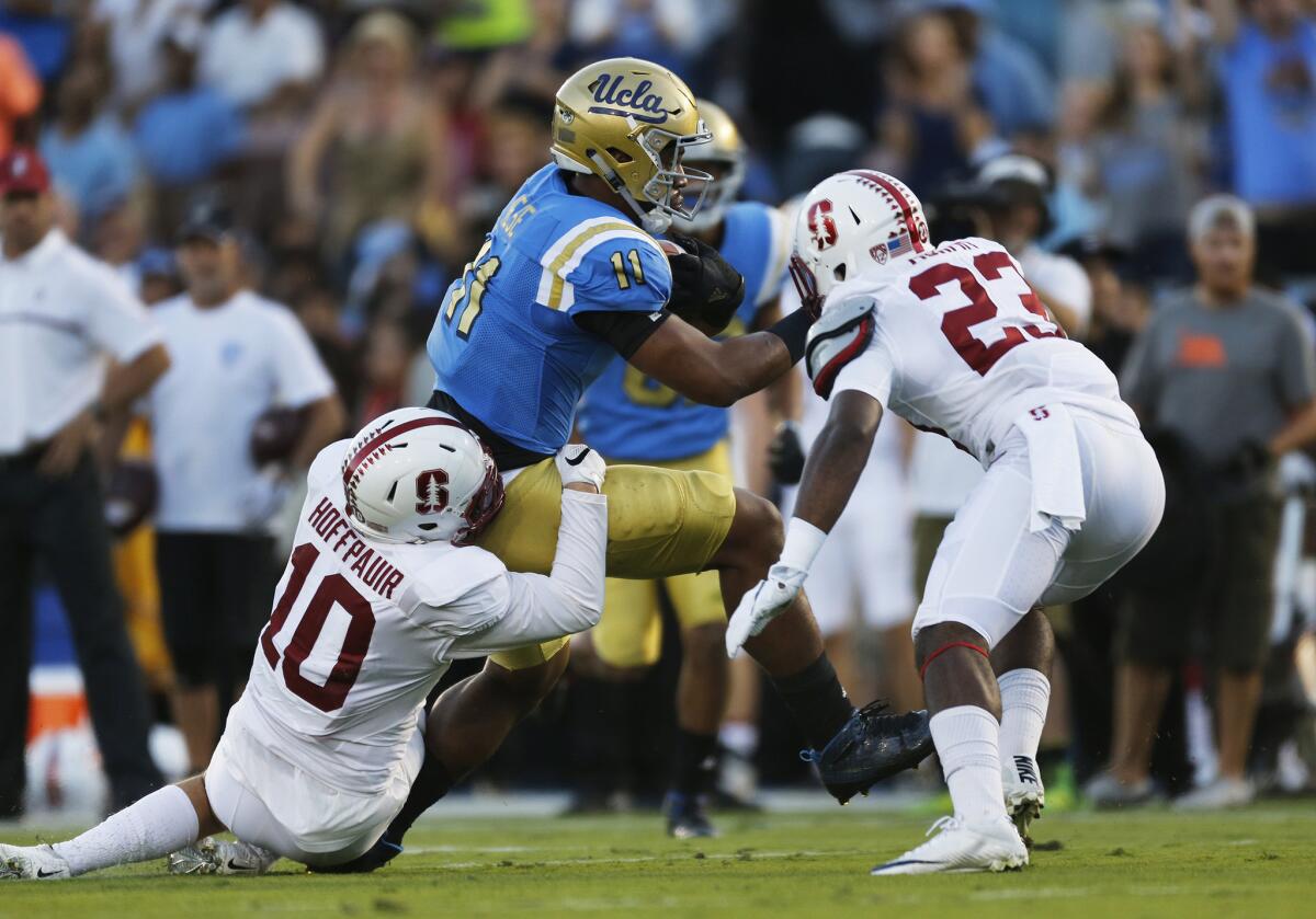 UCLA tight end Nate Iese (11) pulls in a long pass while surrounded by Stanford defenders during the first half on Sept. 24.