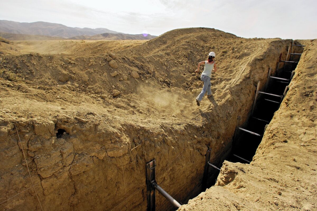 Studying a trench that reveals lines in the sediment helps a team of geologists construct a history of earthquakes on the San Andreas fault in San Luis Obispo County. (Ricardo DeAratanha / Los Angeles Times)