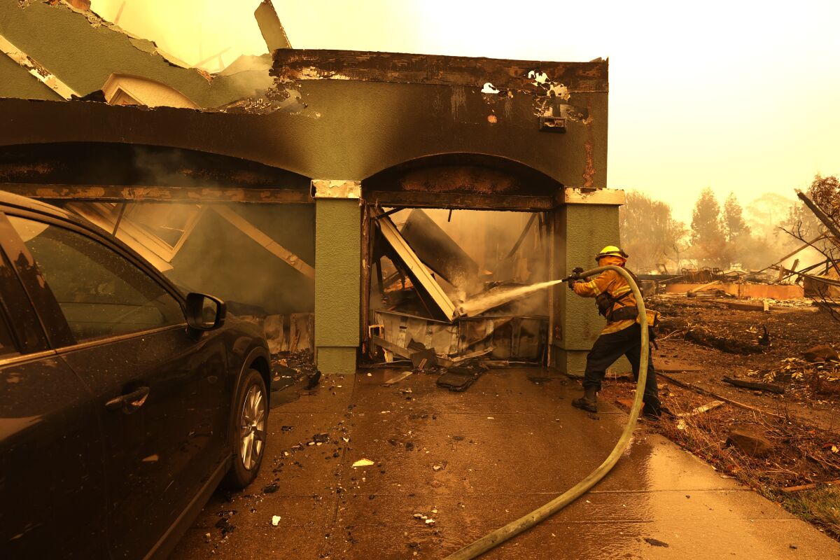 A firefighter at a burned-out home