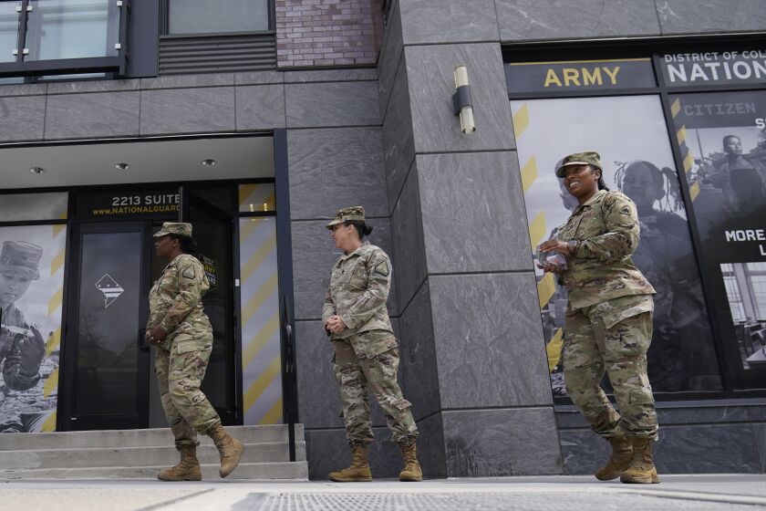 FILE - The U.S. Army National Guard members stand outside the Army National Guard office during training on April 21, 2022, in Washington. The Army fell about 15,000 soldiers — or 25% — short of its recruitment goal this year, officials confirmed Friday, Sept. 30, despite a frantic effort to make up the widely expected gap in a year when all the military services struggled in a tight jobs market to find young people willing and fit to enlist. (AP Photo/Mariam Zuhaib, File)