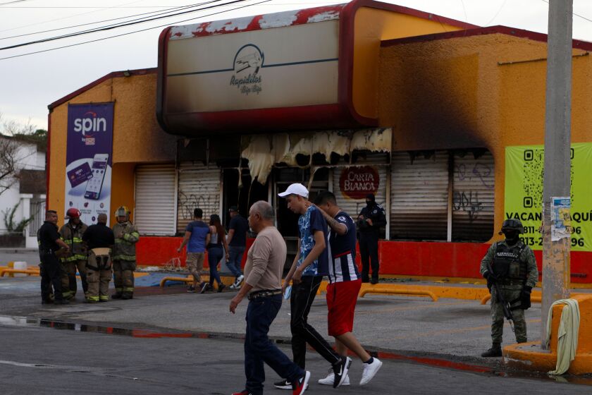 Members of the Mexican Army, firefighters and forensic experts work at the site where unknown persons burnt down shops in Ciudad Juarez, state of Chihuahua, Mexico, on August 11, 2022. (Photo by HERIKA MARTINEZ / AFP) (Photo by HERIKA MARTINEZ/AFP via Getty Images)