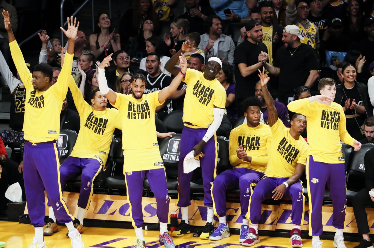 The Lakers bench celebrates a three-pointer by LeBron James in the first quarter Tuesday.
