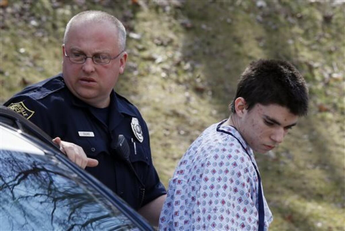 Alex Hribal, the suspect in the multiple stabbings at Franklin Regional High School near Pittsburgh, is escorted by police to his arraignment. Hribal, 16, has been charged as an adult.