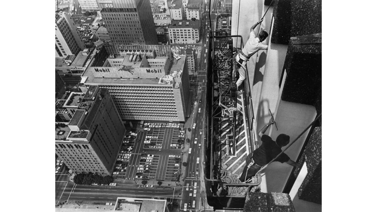 Aug. 19, 1968: Employees of American Building Maintenance Industries stretch from their rig to wash windows near the top of the new Crocker-Citizens tower in downtown Los Angeles. This photo appeared in the Sept. 1, 1968, Los Angeles Times.