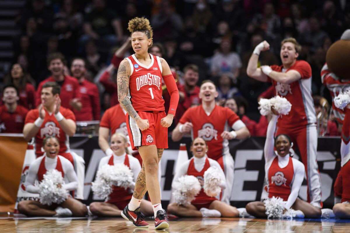 Ohio State guard Rikki Harris (1) flexes after scoring and being fouled in the fourth quarter of a Sweet 16 college basketball game against UConn of the NCAA Tournament in Seattle, Saturday, March 25, 2023. (AP Photo/Caean Couto)