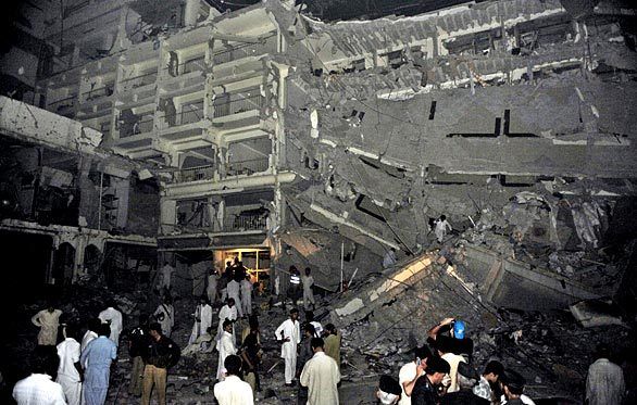 Pakistani police gather at the five-star hotel after a bomb blast. At least 11 people were killed and 50 others injured.