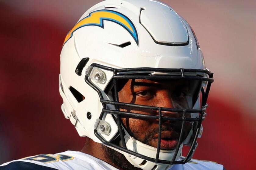 FILE - In this Aug. 31, 2017, file photo, Los Angeles Chargers offensive tackle Russell Okung (76) looks on before a preseason NFL football game against the San Francisco 49ers in Santa Clara, Calif. Okung had $48 million and four years left on his deal with Denver that he never saw, before becoming a free agent and re-upping with San Diego. Professional football players typically don't get to lock in long-term deals with the same financial certainty as their baseball, basketball or hockey peers. (AP Photo/John Hefti, File)