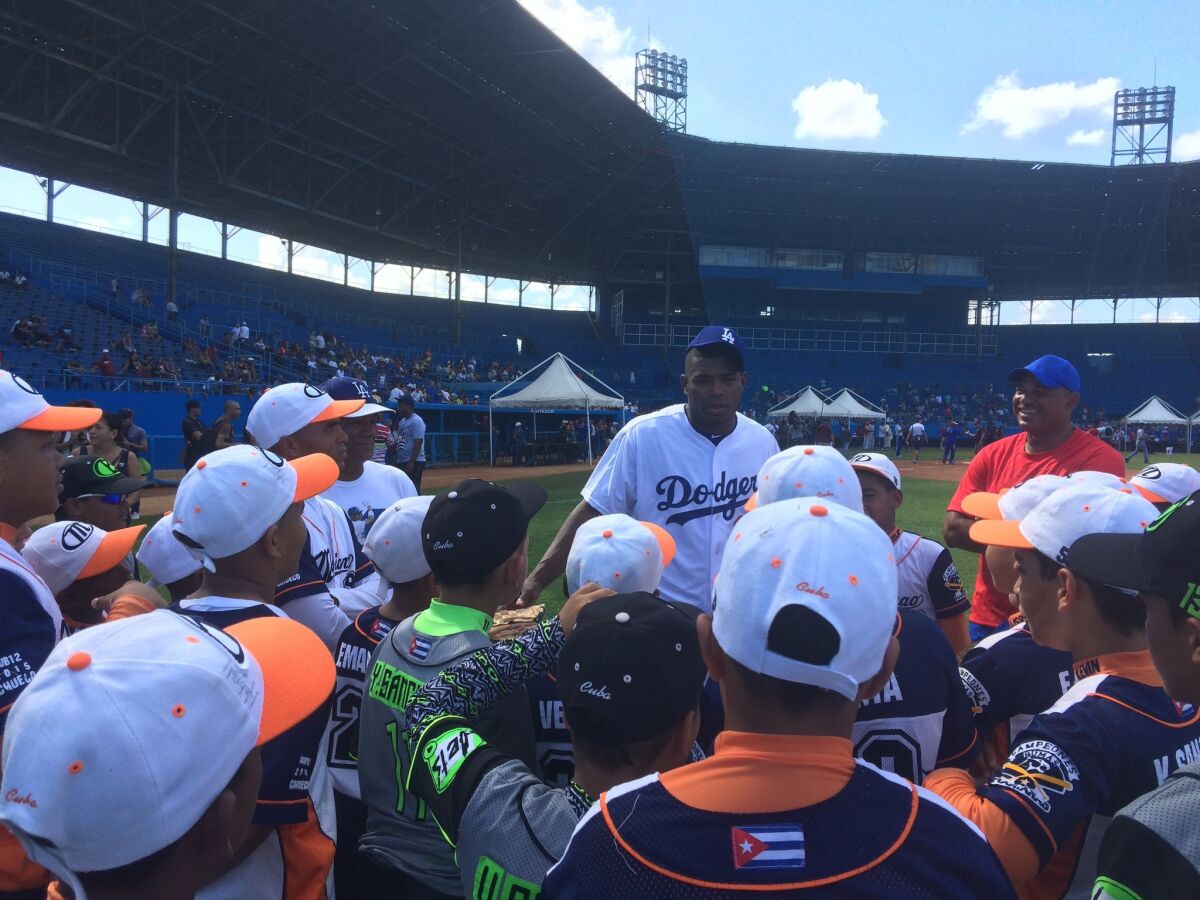 Dodgers outfielder Yasiel Puig talks to Cuban players at Estadio Latinoamericano during a MLB goodwill tour.