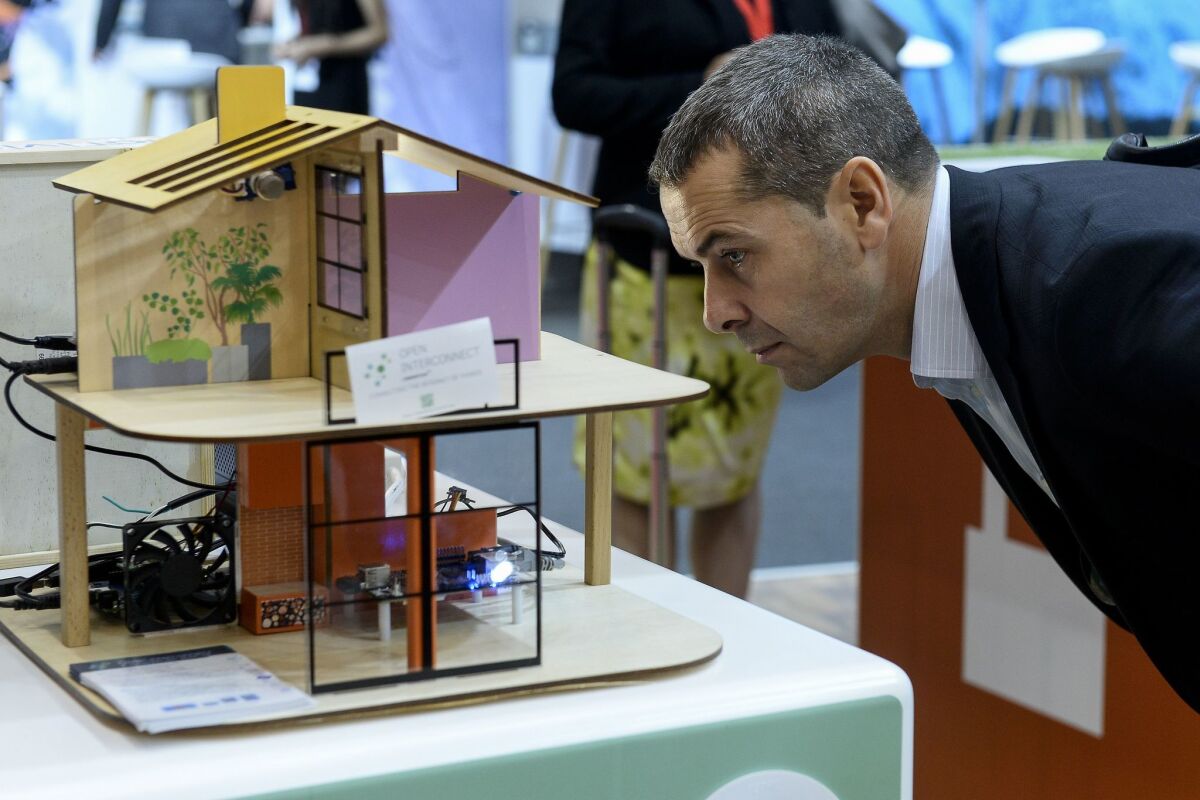A man views a model of a "smart house" at the 2015 Internet of Things Solutions World Congress event in Barcelona on Sept. 16. The three-day conference featured key companies and institutions working in the rapidly growing field of Internet-connected devices.