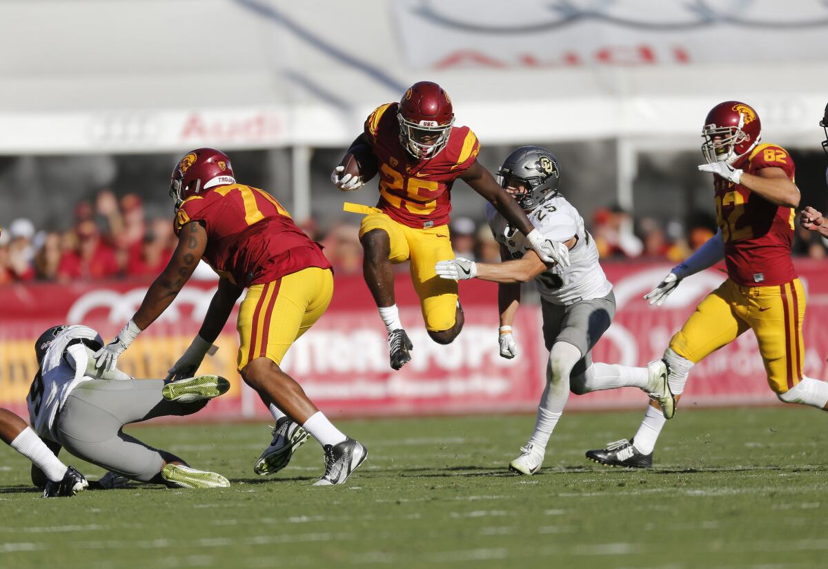 Trojans running back Ronald Jones II finds a hole to leap past Buffaloes defensive back Ryan Moeller in the second half.
