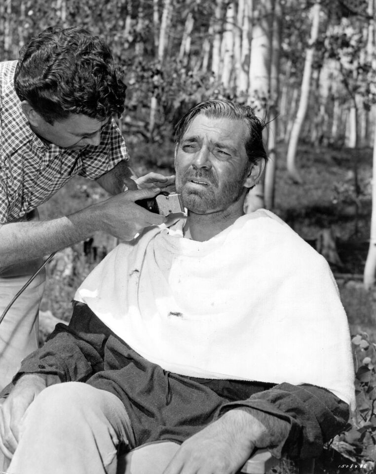 1951: Clark Gable having a shave during filming of the MGM production "Across the Wide Missouri."