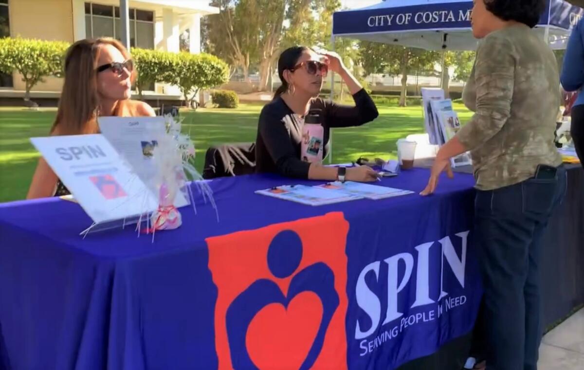 Costa Mesa's nonprofit Serving People in Need (SPIN) talk to residents prior to a June 21 City Council meeting.