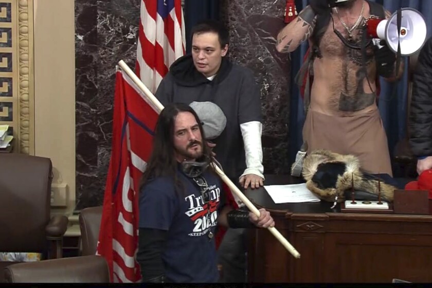 In this image from Senate Television video, Paul Allard Hodgkins, 38, of Tampa, Fla., front, stands in the well on the floor of the U.S. Senate on Jan. 6, 2021, at the Capitol in Washington. Hodgkins' attorney wrote in part, "This country has a long history of the public seeking to punish those who are perceived to have done wrong in 'their' eyes. .... A significant percentage of our population will 'cancel' Mr. Hodgkins because of 15-minutes of bad judgment, casting stones in his directions, all the while never fully realizing their own indiscretions and hypocrisy." (Senate Television via AP)