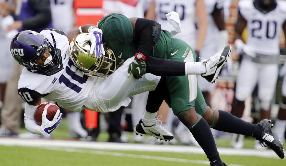 Baylor linebacker Taylor Young brings down TCU wide receiver Matt Brown during the Bears' 61-58 victory in a Big 12 Conference game earlier this season.