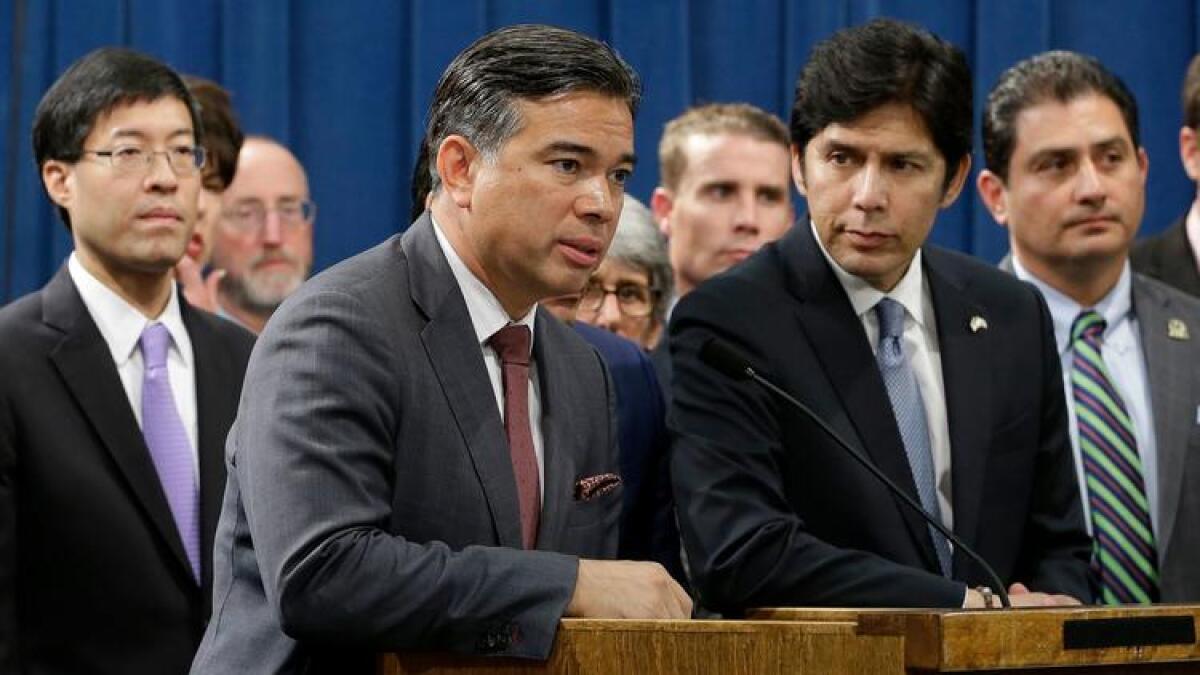 Gov. Jerry Brown signed climate legislation from Assemblyman Rob Bonta, center.