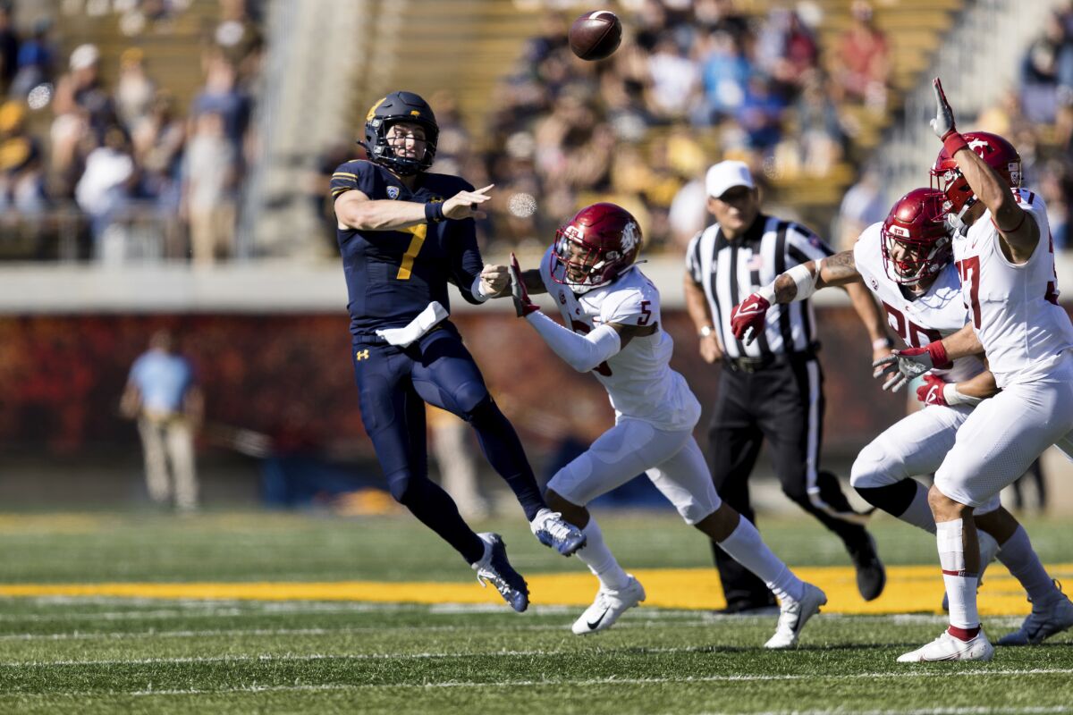 California quarterback Chase Garbers (7) throws a pass under pressure from Washington State defensive back Derrick Langford (5) in the second quarter of an NCAA college football game in Berkeley, Calif., Saturday, Oct. 2, 2021. (AP Photo/John Hefti)