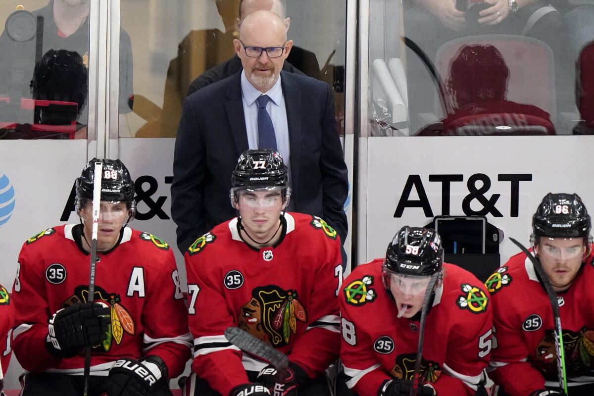 Chicago Blackhawks interim head coach Derek King, top, watches his team during the first period of an NHL hockey game against the Nashville Predators in Chicago, Sunday, Nov. 7, 2021. (AP Photo/Nam Y. Huh)
