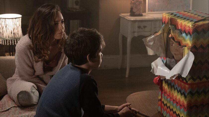 Aubrey Plaza as Karen Barclay and Gabriel Bateman as Andy meet Chucky, the new Kaslan Corp. child companion doll, in 2019's "Child's Play" reboot.