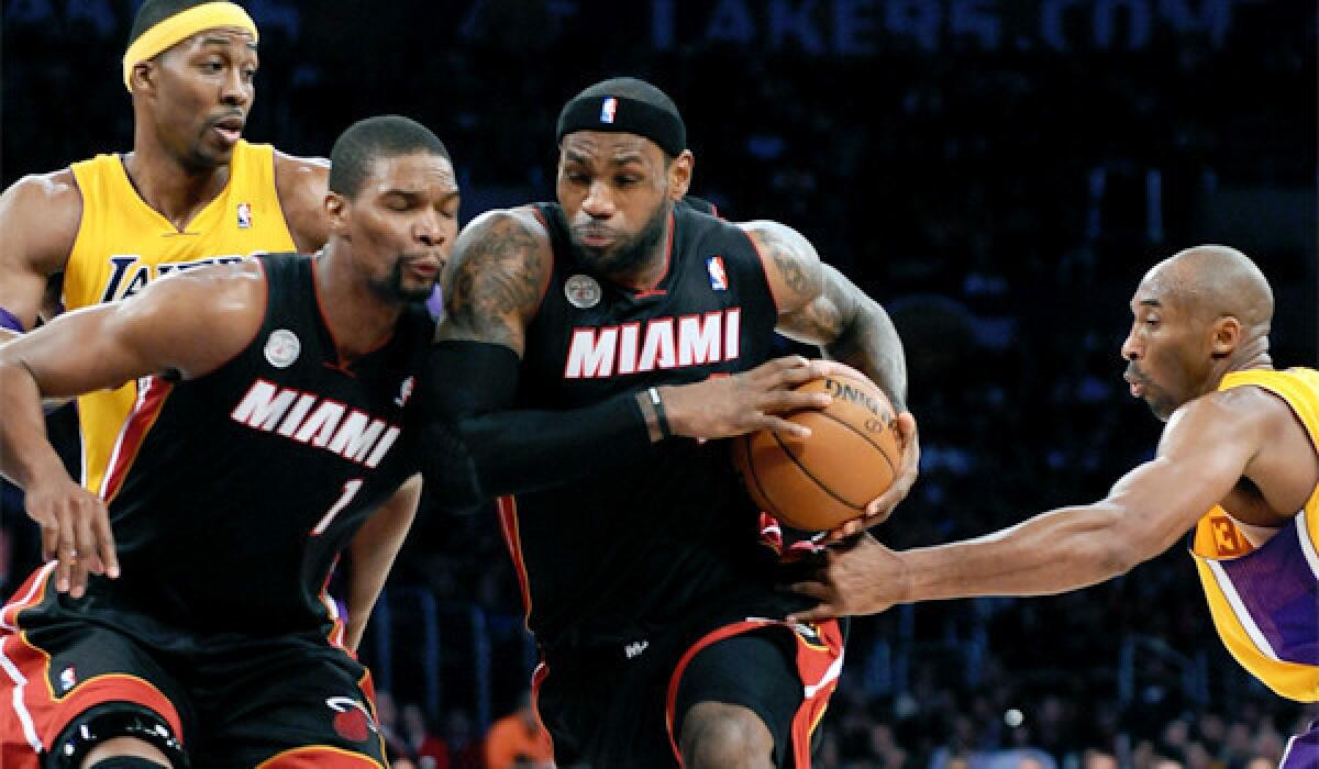 LeBron James, center, is averaging 26.9 points, 8.1 rebounds and 6.9 assists a game for the Heat this season.