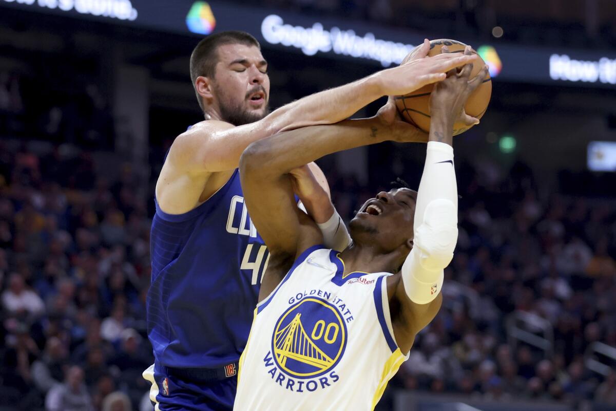 Clippers center Ivica Zubac blocks a shot by Warriors forward Jonathan Kuminga.