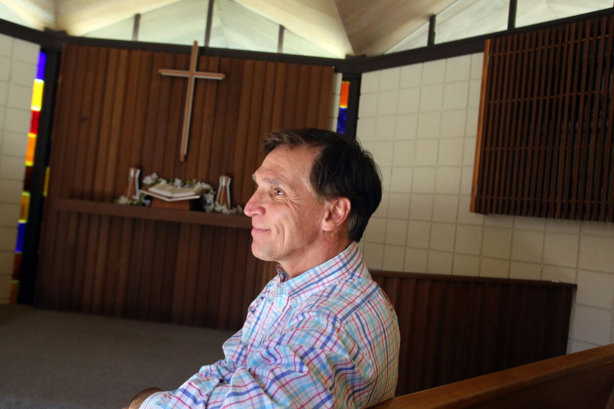 Tyler Wright, the chief executive and president of YMCA of the Foothills, sits in the Samuelson Chapel at the Crescenta-Cañada Y in La Cañada on Tuesday. Wright is leaving his post after nearly 10 years for a similar position in Portland, Ore.