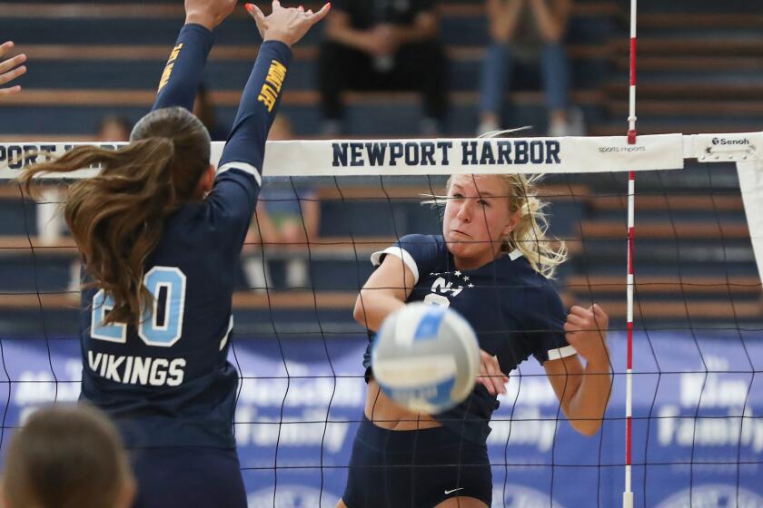 Ella Olson (2) Newport Harbor, puts a kill away into open space down the line during Sunset League girls' volleyball match against Marina on Tuesday.