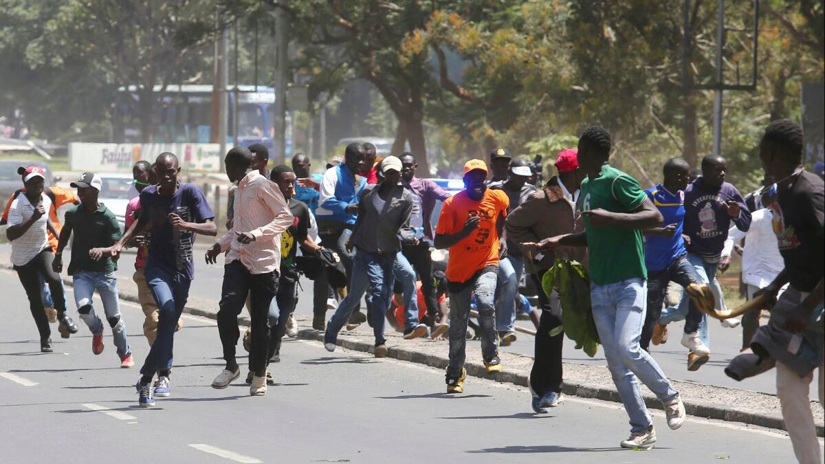 Kenyan opposition supporters flee tear gas Jan. 30 in the capital, Nairobi.