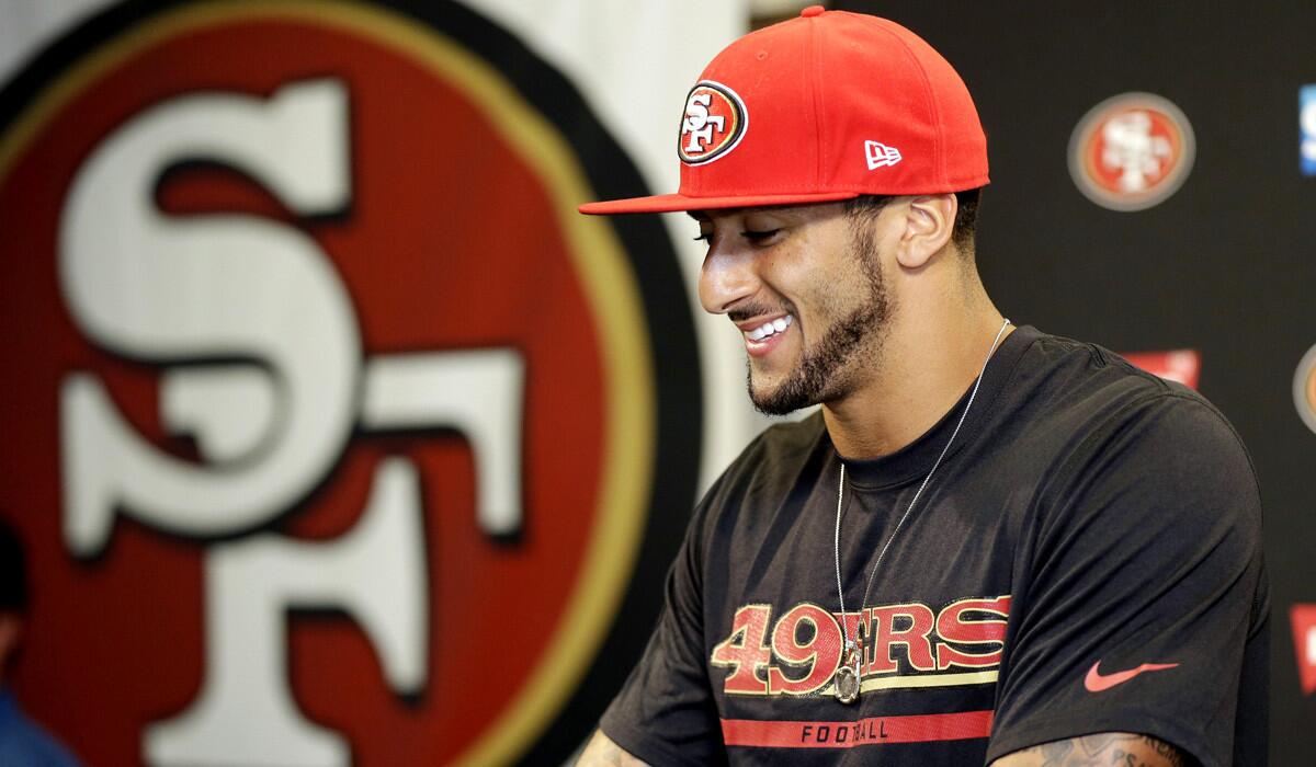 Quarterback Colin Kaepernick addresses the media last week after signing a six-year contract extension with the San Francisco 49ers.