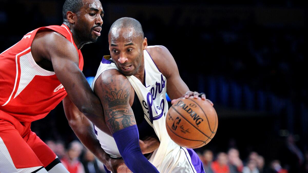 Lakers guard Kobe Bryant drives around Clippers forward Luc Mbah a Moute during their game Friday.