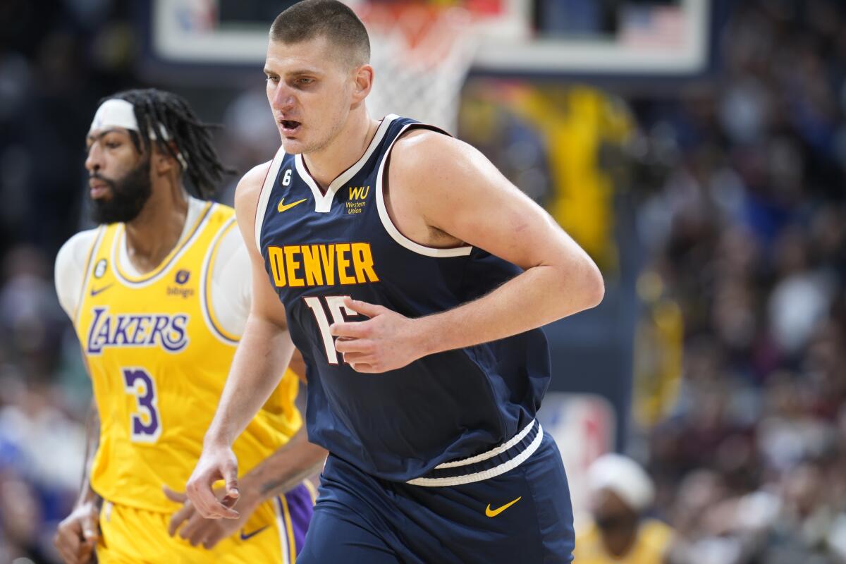 Denver Nuggets center Nikola Jokic reacts after hitting a basket over Lakers forward Anthony Davis.